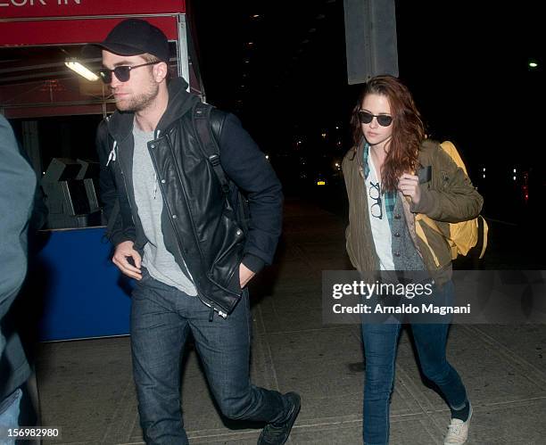 Robert Pattinson and Kristen Stewart arrive at JFK airport on November 26, 2012 in New York City.