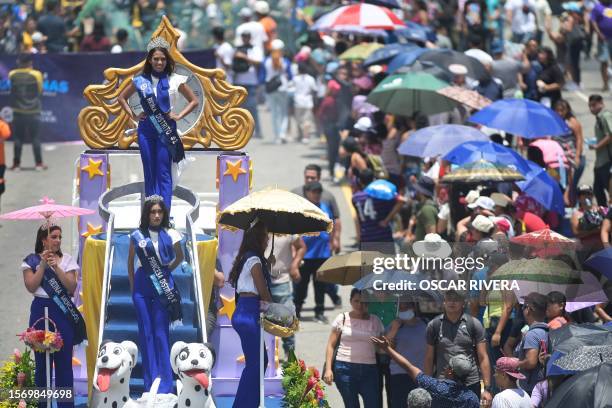 Revellers take part in a parade marking the beginning of the festival of the Divino Salvador del Mundo , San Salvador's patron saint, in San Salvador...