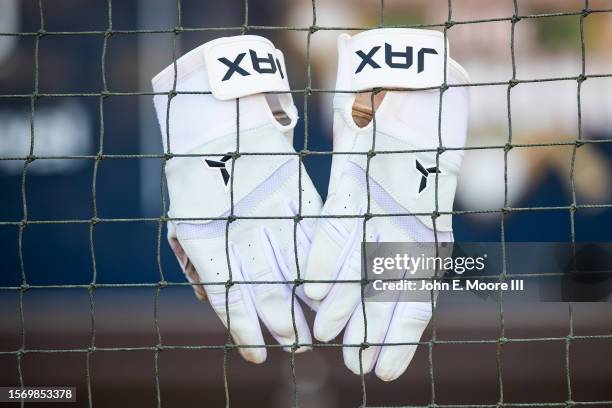 Pair of Jax batting gloves hangs from the dugout netting before the game between the Amarillo Sod Poodles and the Wichita Wind Surge at HODGETOWN...