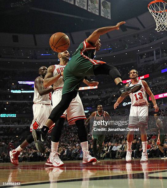 Tobias Harris of the Milwaukee Bucks looses control of the ball after being fouled by Carlos Boozer of the Chicago Bulls at the United Center on...