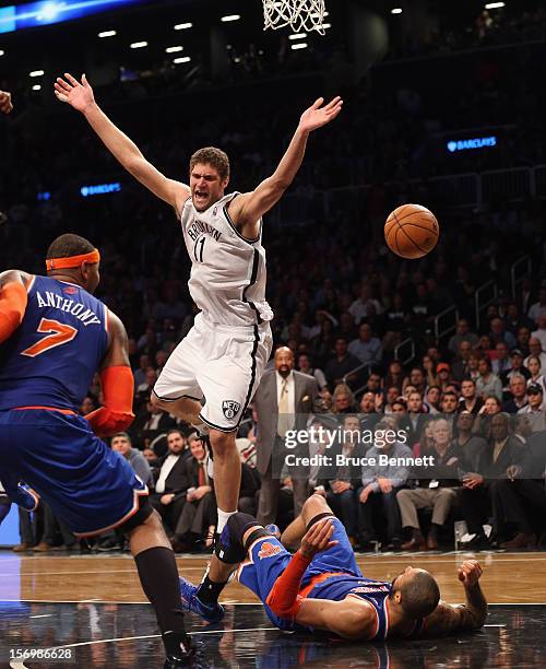 Brook Lopez of the Brooklyn Nets is called for an offensive foul against Tyson Chandler of the New York Knicks in the final minute of regulation at...