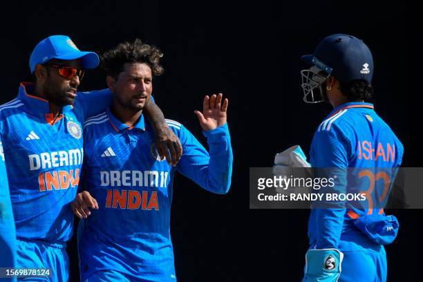 Kuldeep Yadav and Suryakumar Yadav of India celebrate the dismissal of Alick Athanaze of the West Indies during the 3rd and final ODI match between...