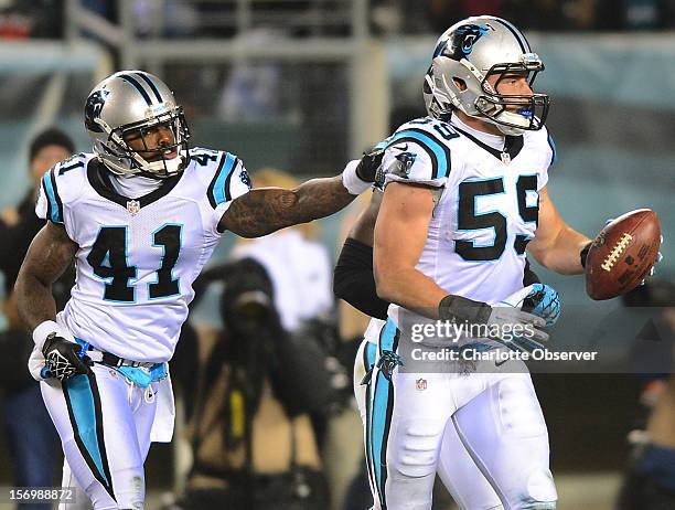 Carolina Panthers cornerback Captain Munnerlyn congratulates linebacker Luke Kuechly after he recovered a fumble by Philadelphia Eagles running back...
