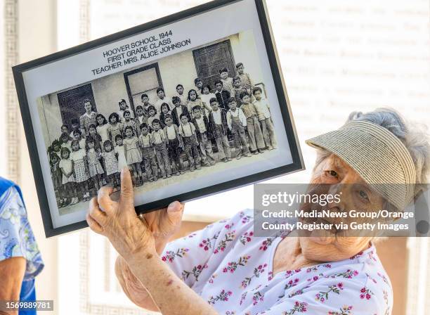 Louisa Hernandez points to her self on a 1944 Hoover School first grade class photo during a reunion of former students from the segregated Mexican...