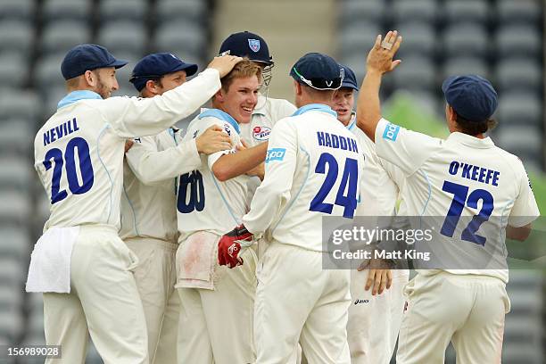 Adam Zampa of the Blues celebrates with team mates after taking the wicket of Chris Hartley of the Bulls during day one of the Sheffield Shield match...