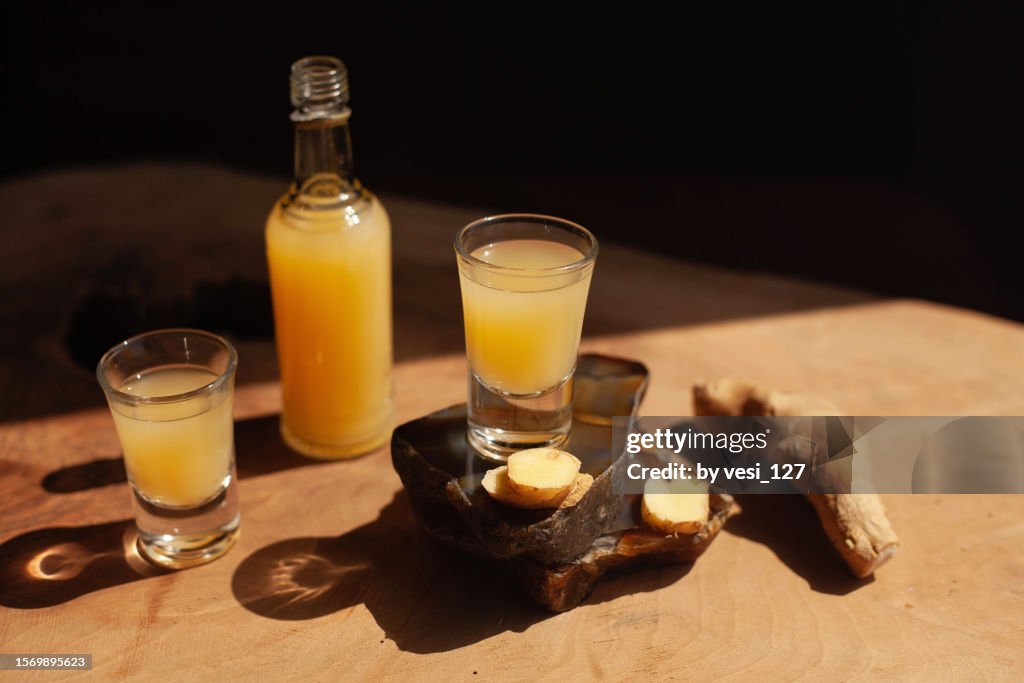 Ginger shots on a wooden surface