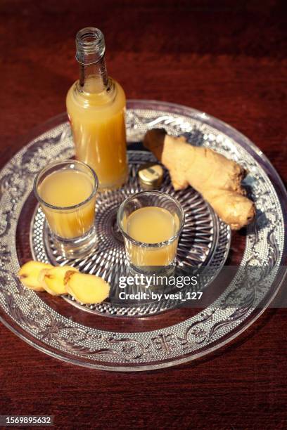 ginger shots on a wooden table - ginger glasses stock-fotos und bilder