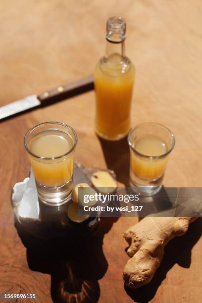 ginger shots on a wooden surface - shot glass stock pictures, royalty-free photos & images