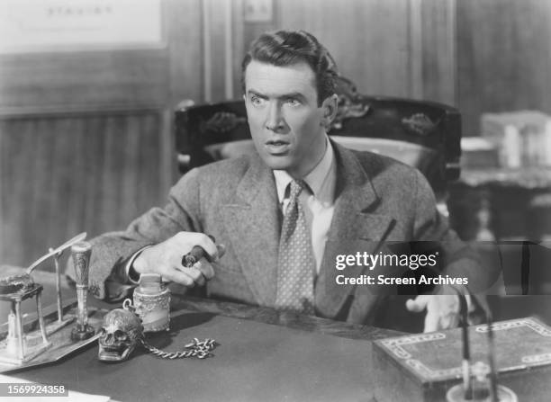 James Stewart as George Bailey smoking cigar in the Frank Capra film 'It's a Wonderful Life', 1946.