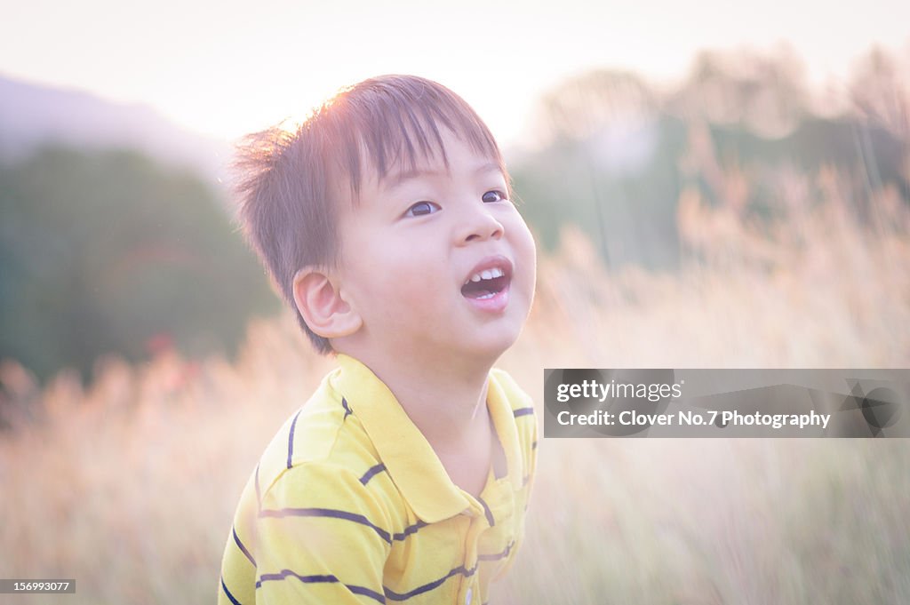 Sunset under a smiling boy