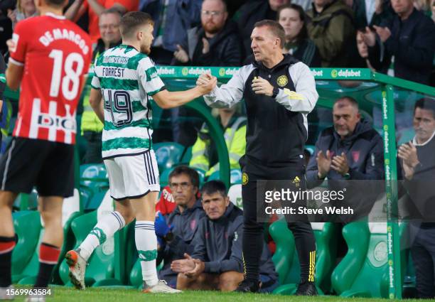 James Forrest of Celtic comes off and shakes the hand of the Celtic manager Brendan Rodgers during the pre-season friendly match between Celtic and...