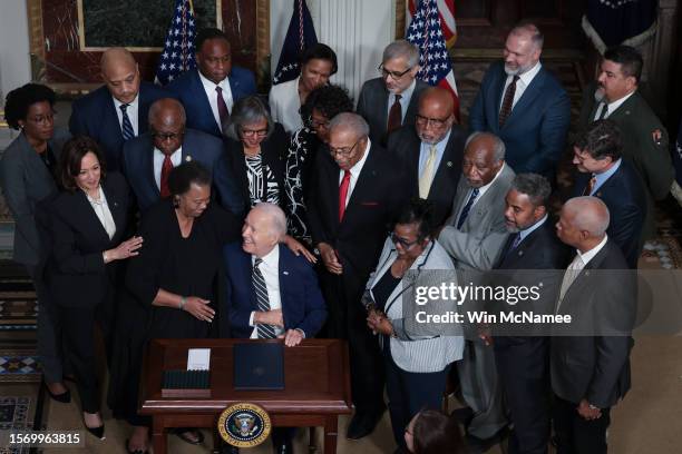 President Joe Biden, applauded by members of the Till family and members of Congress, finishes signing a proclamation in the Indian Treaty Room to...