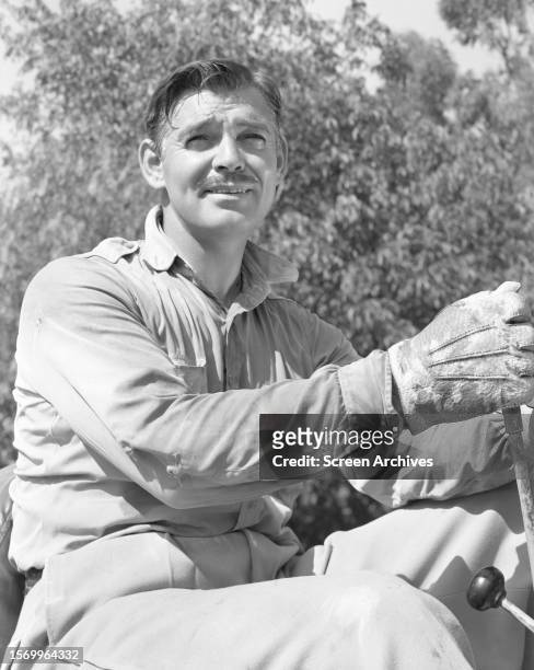 Clark Gable poses on tractor for a 1944 portrait.