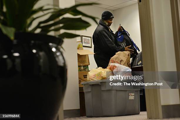 Jean Kabre's office, where he works as a concierge and event planner at 101 Constitution Avenue, houses donations for his home village on Tuesday,...