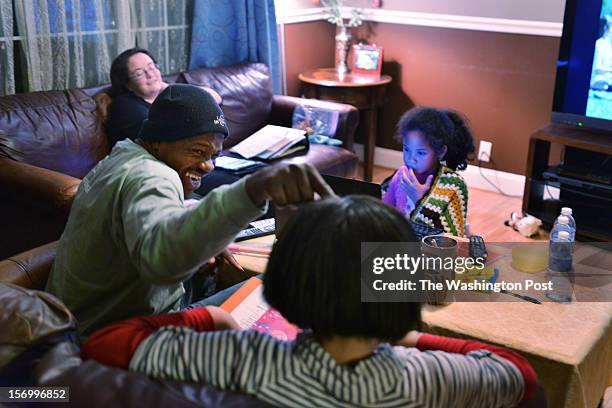 Jean Kabre teases with his daughter, Timbila Kabre as they discuss homework at the Kabre home on Thursday, November 13 in Woodbridge, VA. Jean's wife...