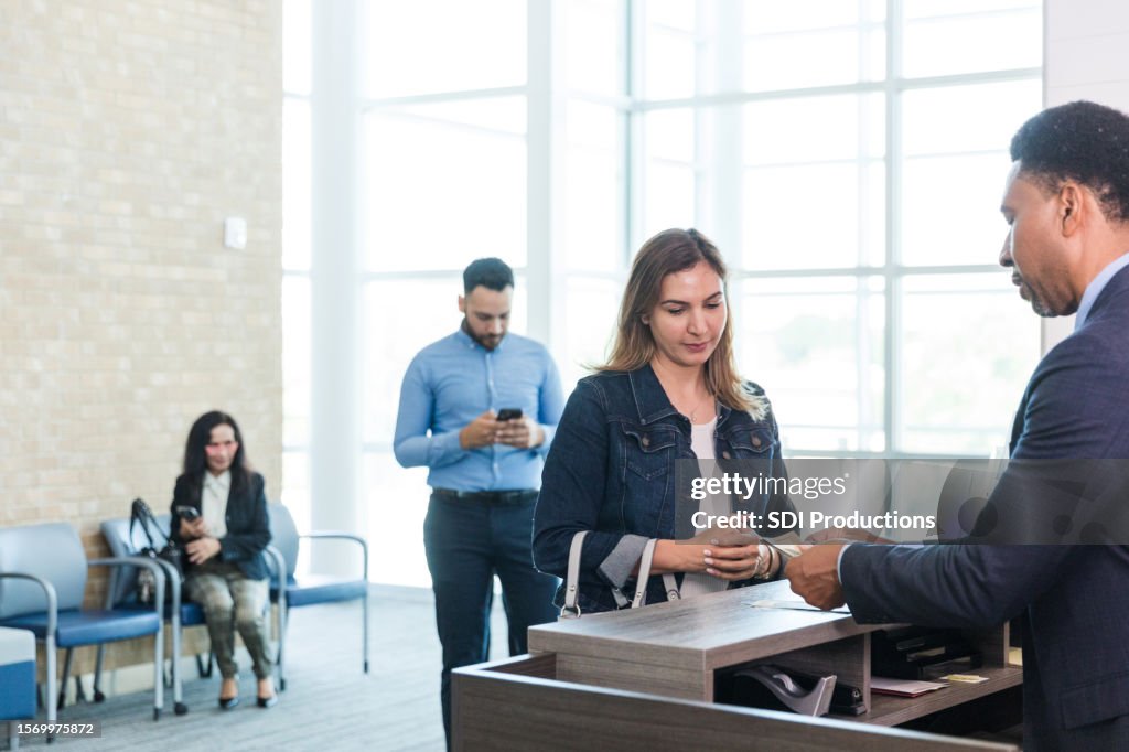 Woman listens as banker explains loan application paperwork