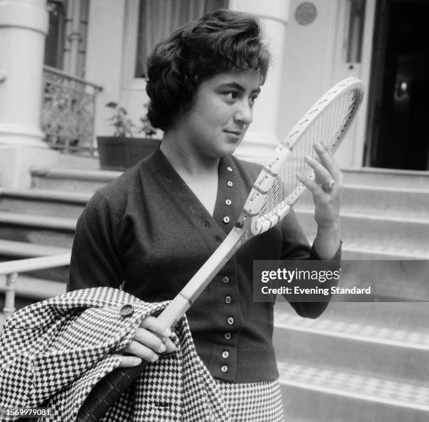 Mexican tennis player Rosie Reyes holds a tennis racket outside a house in London, July 3rd 1959. Reyes was competing in the Women's Doubles...