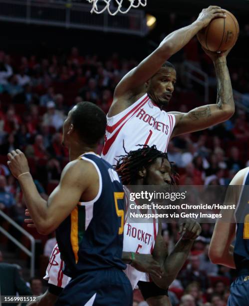 Houston Rockets forward Trevor Ariza pulls down a rebound over Rockets forward Montrezl Harrell and Utah Jazz guard Rodney Hood during the first half...