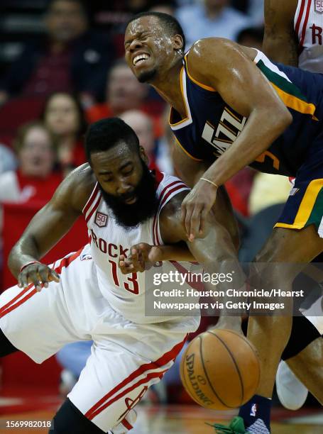 Houston Rockets guard James Harden goes to the floor after a loose ball against Utah Jazz guard Rodney Hood during the third quarter of an NBA...