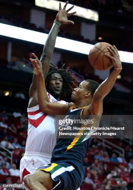 Houston Rockets forward Montrezl Harrell, left, defends a shot by Utah Jazz guard Rodney Hood during the first half of an NBA basketball game at...