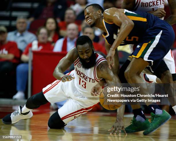 Houston Rockets guard James Harden goes to the floor after a loose ball against Utah Jazz guard Rodney Hood during the third quarter of an NBA...