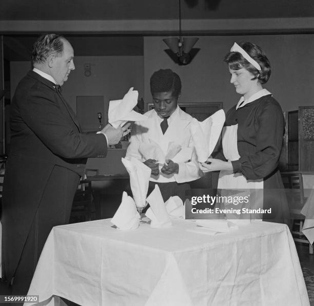 Catering students receive instruction in napkin folding at Thanet Technical College, January 15th 1960. The college was later renamed East Kent...