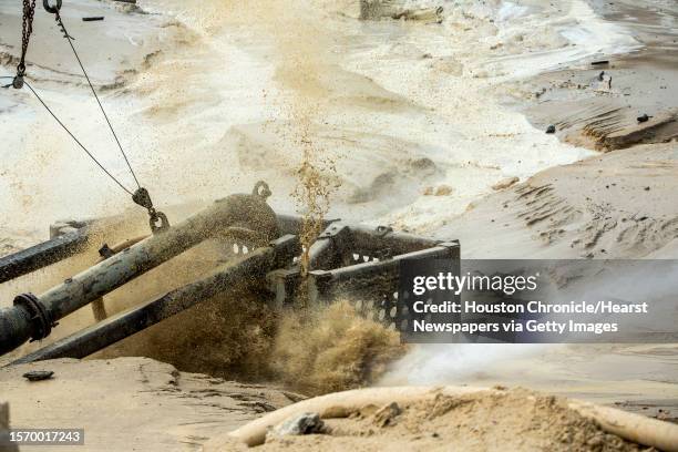 Sand is pushed into an intake pipe for further processing at the Superior Silica Sands sand mine on Tuesday, March 28 in Kosse, Texas. Demand for...