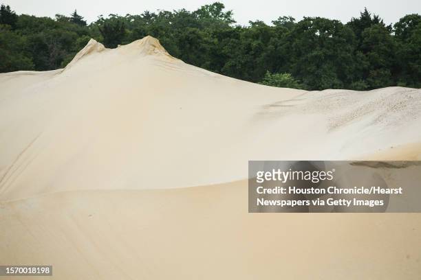 Sand piles at the Superior Silica Sands sand mine are shown on Tuesday, March 28 in Kosse, Texas. Demand for sand is surging as oil and gas...