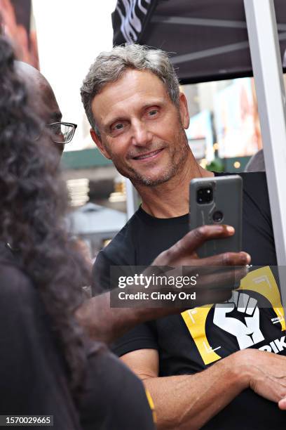 Tony Goldwyn attends as SAG-AFTRA members hold "Rock The City For A Fair Contract" rally in Times Square on July 25, 2023 in New York City. Members...