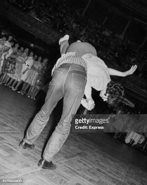 British dancers Eric Winward and Sheree Bates - with Sheree on Eric's back - compete in the Rock 'n' Roll dance championships, in London, England,...