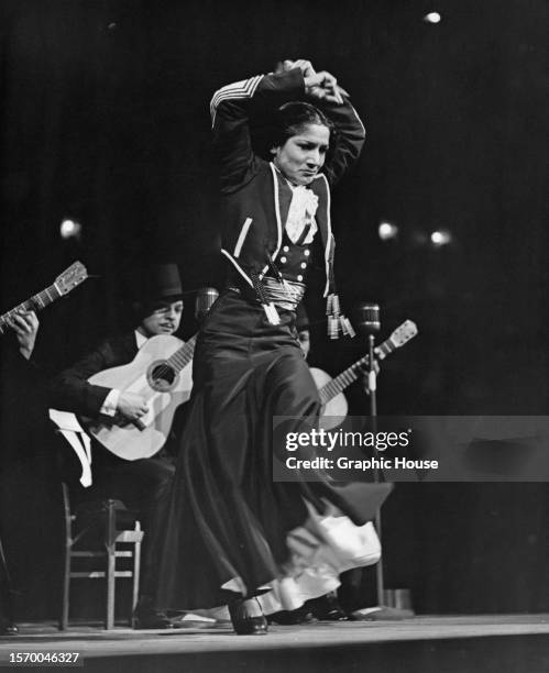 Spanish singer and dancer Carmen Amaya dancing the Flamenco, with a row of guitarists in the background, on stage at the 'Night of Stars', held at...