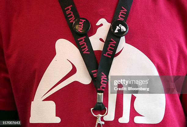 An employee wears a branded lanyard and T-shirt in this arranged photograph at a HMV pop-up store in London, U.K., on Tuesday, Nov. 27, 2012. Fashion...