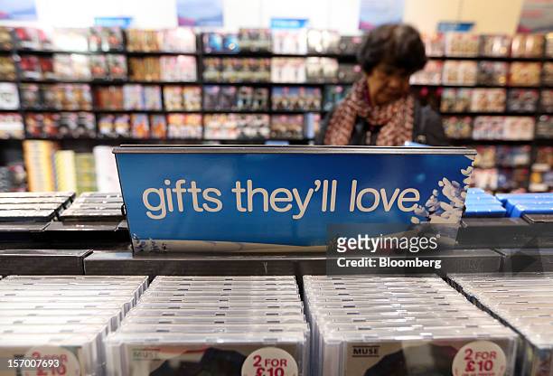 Customer browses CDs on offer inside a HMV pop-up store in London, U.K., on Tuesday, Nov. 27, 2012. Fashion chain Hobbs is among those that have...