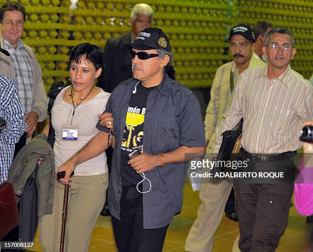 Leftist guerrilla delegates, commander Jesus Santrich and fighters Ruben Zamora and Maritza Garcia , arrive at the Convention Palace in Havana for...