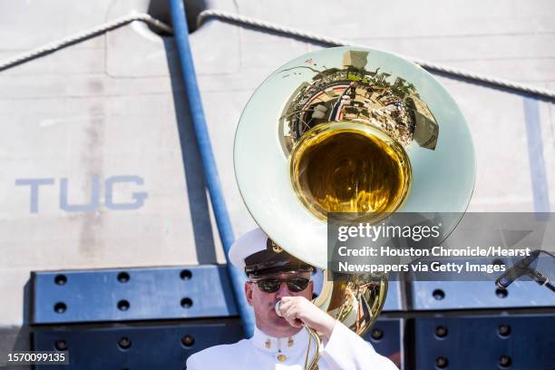 Senior Chief David Bogart warms up on a sousaphone before the commissioning ceremony for the U.S.S. Gabrielle Giffords LCS-10 on Saturday, June 10 in...