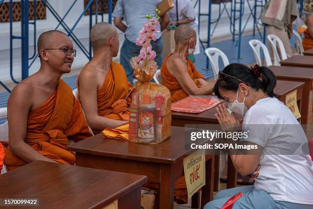 Thai Buddhist devotee pays respect to the Thai Buddhist monks during the Buddhist Lent Day ceremony at Wat Saket in Bangkok. The Buddhist Lent Day is...