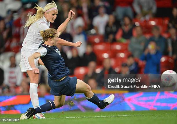Rachel Buehler of USA challenges for the ball with Kaylyn Kyle of Canada during the Women's Football Semi Final match between Canada and USA, on Day...