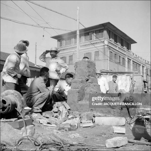 Employees of the Shin Chiao Hotel in Beijing build in the hotel courtyard in October 1958 a small and rudimentary smelting steel furnace during the...