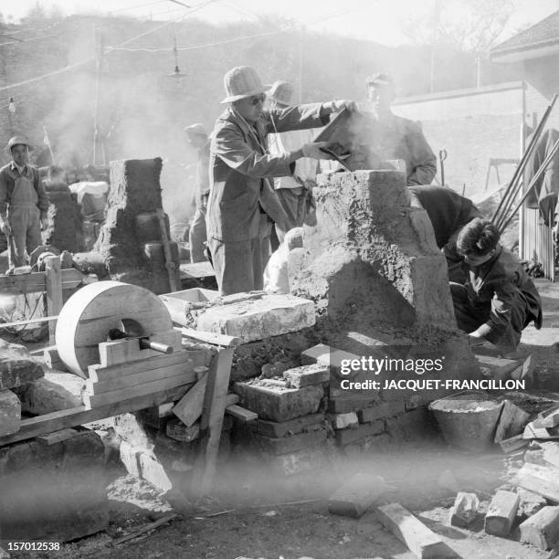 Employees of the Shin Chiao Hotel in Beijing build in the hotel courtyard in October 1958 a small and rudimentary smelting steel furnace during the...