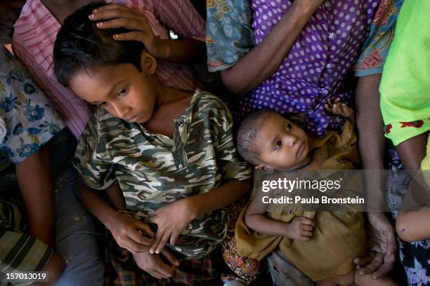 Rohingya wait for medical care at a school that is now a makeshift IDP camp November 24, 2012 on the outskirts of Sittwe, Myanmar. An estimated...