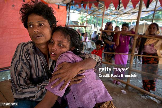 Mohammed Shamim holds his sick wife Mumtaz at a government run medical clinic November 25, 2012 on the outskirts of Sittwe, Myanmar. Mumtaz was later...