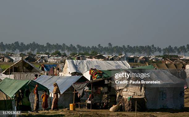 Rohingya families crowd a tented camp November 25, 2012 on the outskirts of Sittwe, Myanmar. An estimated 111,000 people were displaced by sectarian...