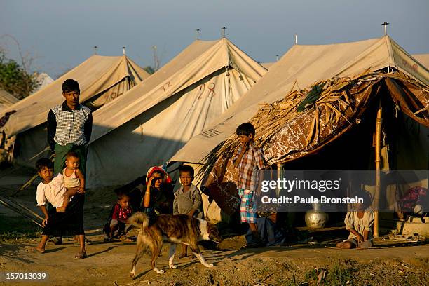 Rohingya families crowd a tented camp November 25, 2012 on the outskirts of Sittwe, Myanmar. An estimated 111,000 people were displaced by sectarian...