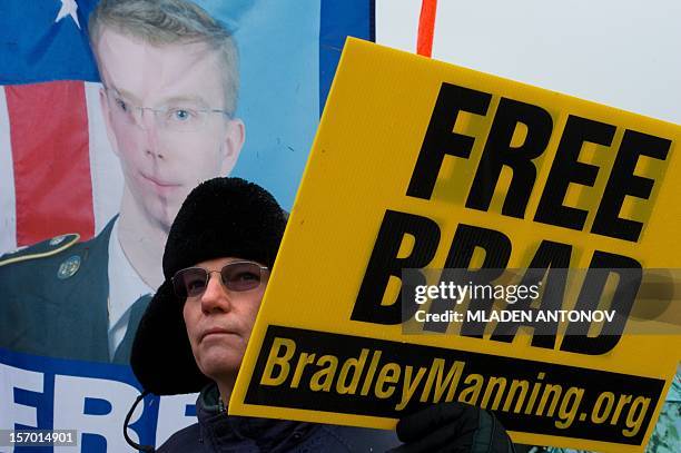 Protesters from the Bradley Manning Support Group holds a sign during a rally at the entrance of Fort George G. Meade military base in Fort Meade,...