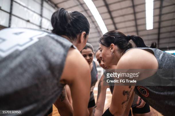 female volleyball players stacking hands before the game on the sports court - hand stack stock pictures, royalty-free photos & images