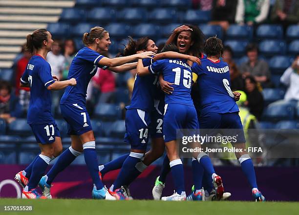 Wendie Renard of France celebrates with her team mates after scoring her team's second goal during the Women's Football Quarter Final match between...