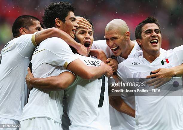 Javier Cortes of Mexico celebrates with his team mates after scoring his team's third goal during the Men's Football Semi Final match between Mexico...