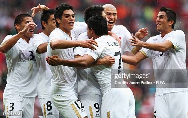Javier Cortes of Mexico celebrates with his team mates after scoring his team's third goal during the Men's Football Semi Final match between Mexico...