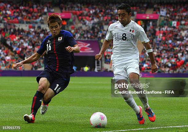 Marco Fabian of Mexico is chased by Hotaru Yamaguchi of Japan during the Men's Football Semi Final match between Mexico and Japan, on Day 11 of the...