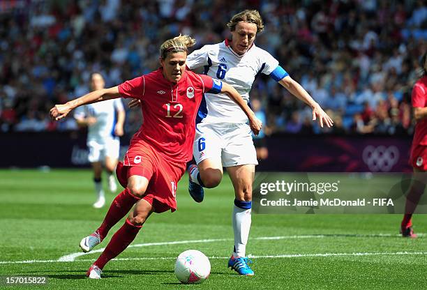 Christine Sinclair of Canada battles with Sandrime Soubeyraind of France during the Women's Football Bronze Medal match between Canada and France, on...